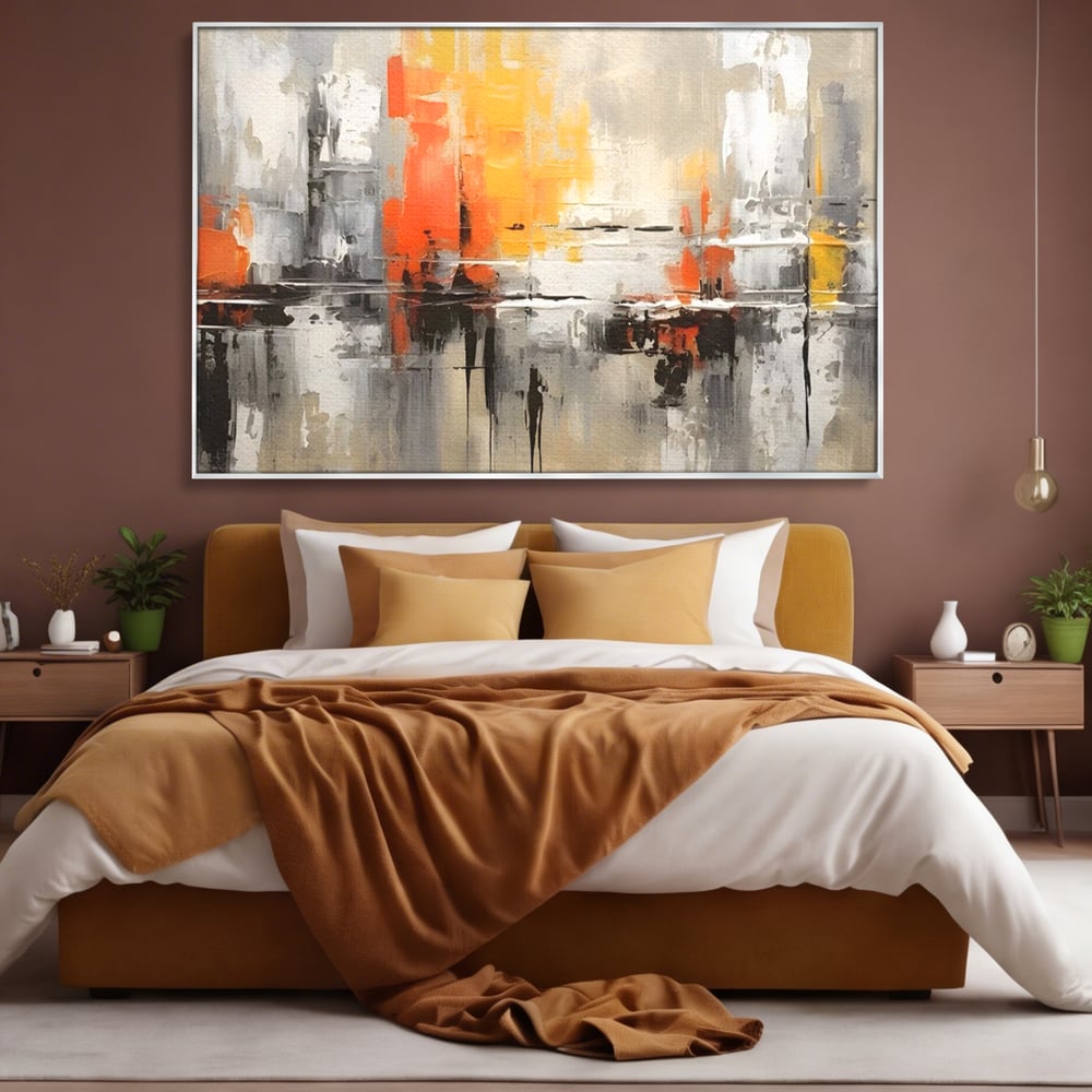 Tablou canvas cu pictura abstracta cu turnuri portocalii, in rama de aluminiu argintiu, pe perete intr-un dormitor